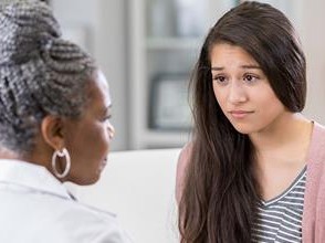 teen talking with doctor